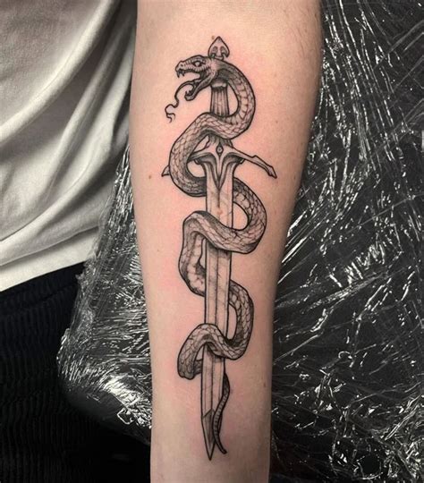 gucci snake arm tattoo|snake wrapped around sword tattoo.